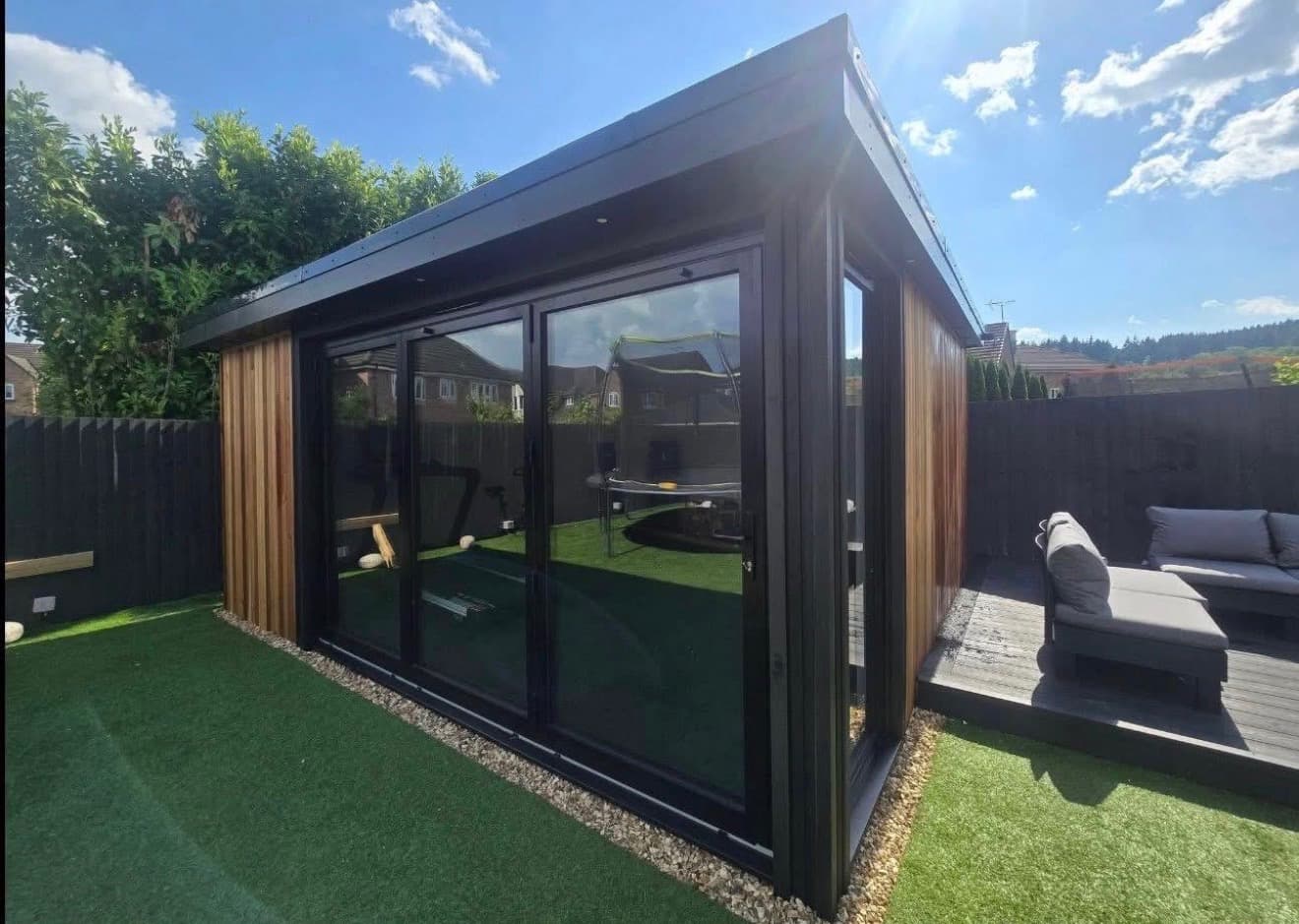 Contemporary garden room with cedar cladding and decking, installed by Evans Fencing & Landscapes