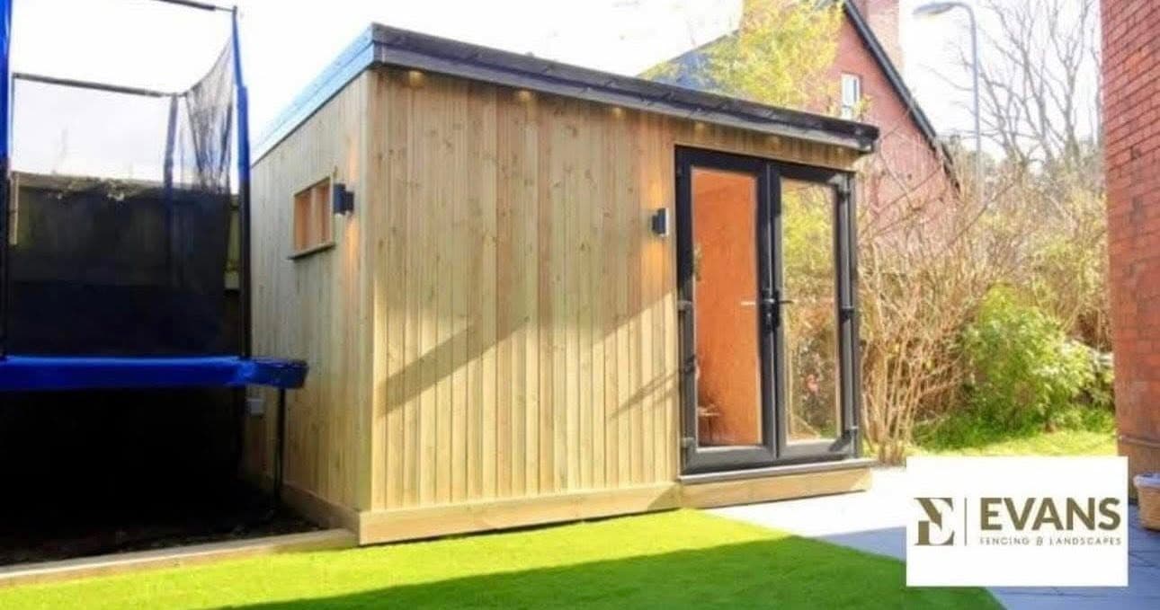 Cedar-clad garden room with black bi-fold doors by Evans Fencing & Landscapes